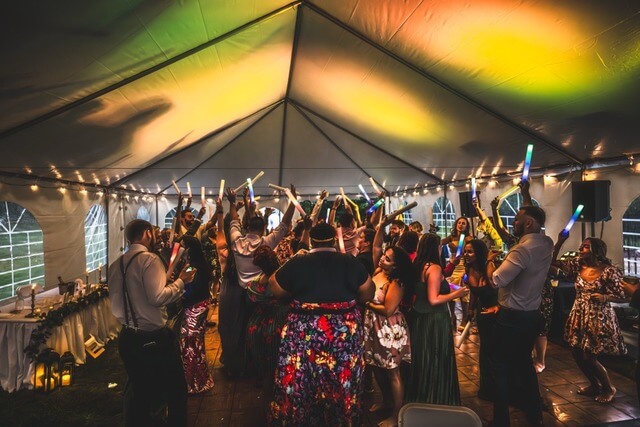 A packed dance floor lit warm