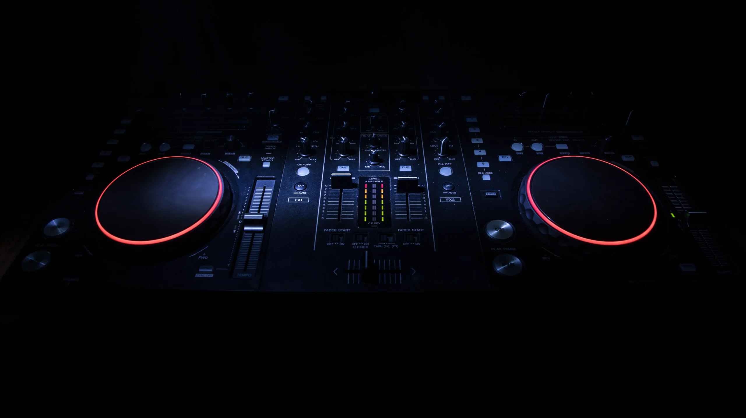A DJ controller lit in the dark
